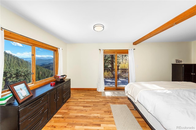 bedroom with light hardwood / wood-style flooring, access to outside, and beamed ceiling