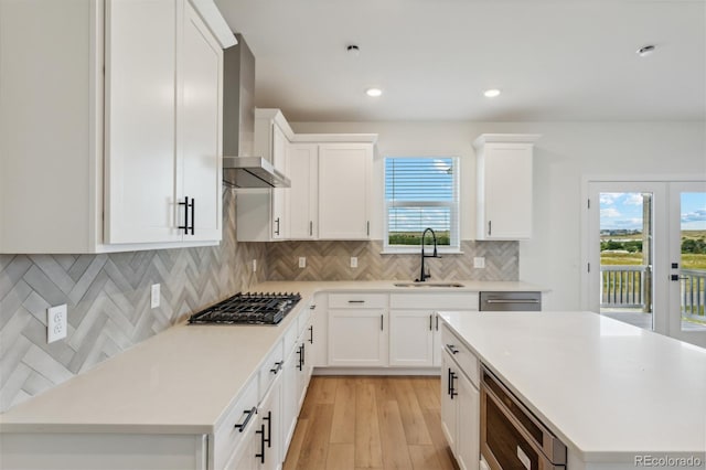 kitchen with appliances with stainless steel finishes, sink, and white cabinets