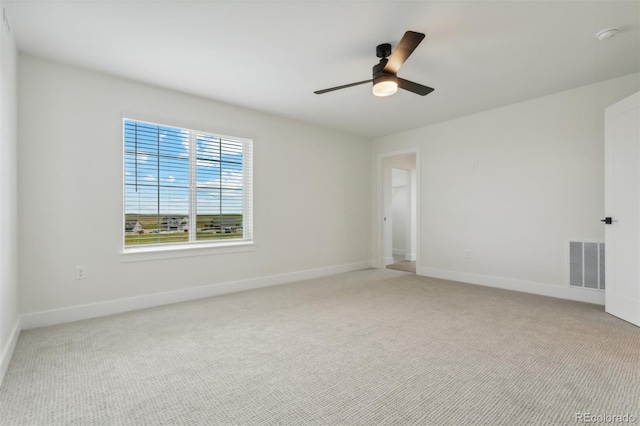 unfurnished room with ceiling fan and light colored carpet