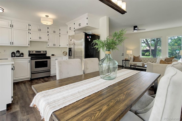 dining space with dark hardwood / wood-style flooring and ceiling fan