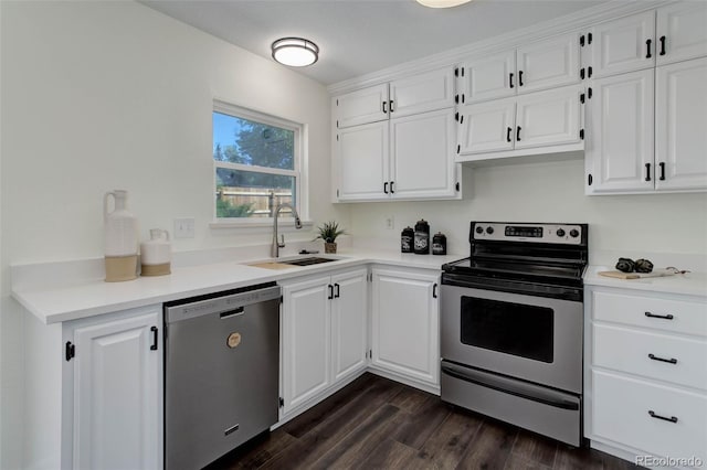 kitchen with appliances with stainless steel finishes, sink, dark wood-type flooring, and white cabinets