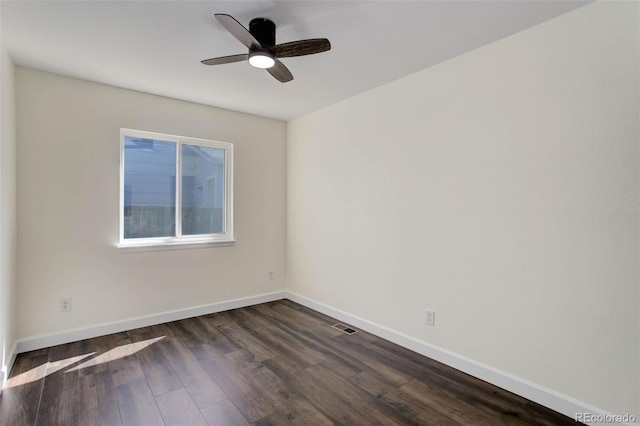 spare room with ceiling fan and dark hardwood / wood-style flooring