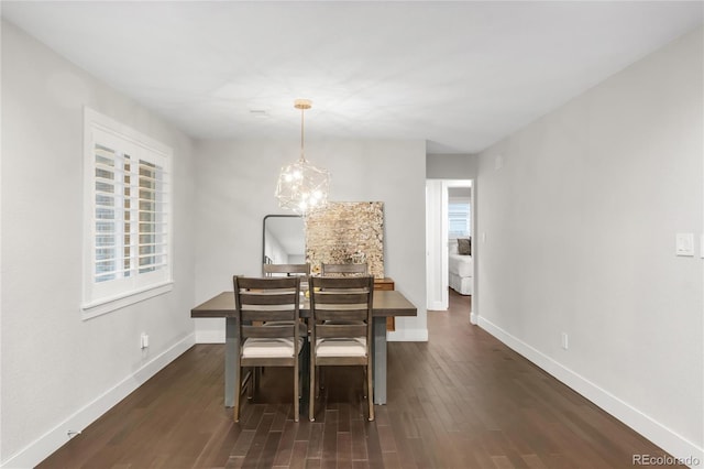 9861 E Ohio Ave, Denver, CO 80247 - dining area with baseboards, dark wood-style flooring, and a chandelier