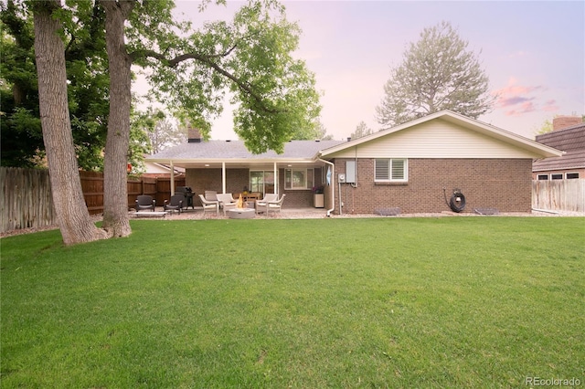 9861 E Ohio Ave, Denver, CO 80247 - rear view of property featuring brick siding, a patio, a fire pit, and a chimney