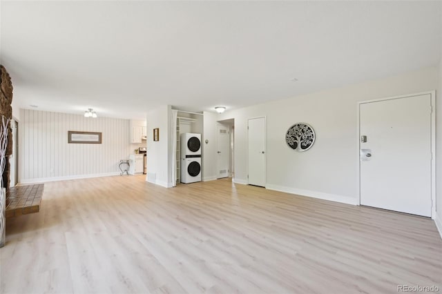 3365 Chisholm Trl Unit B102, Boulder, CO 80301 - unfurnished living room with stacked washer / dryer, light wood-type flooring, and baseboards