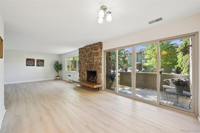 3365 Chisholm Trl Unit B102, Boulder, CO 80301 - unfurnished living room with wood finished floors, baseboards, and a stone fireplace