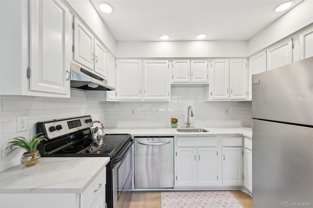 3365 Chisholm Trl Unit B102, Boulder, CO 80301 - kitchen featuring appliances with stainless steel finishes, a sink, under cabinet range hood, white cabinetry, and recessed lighting