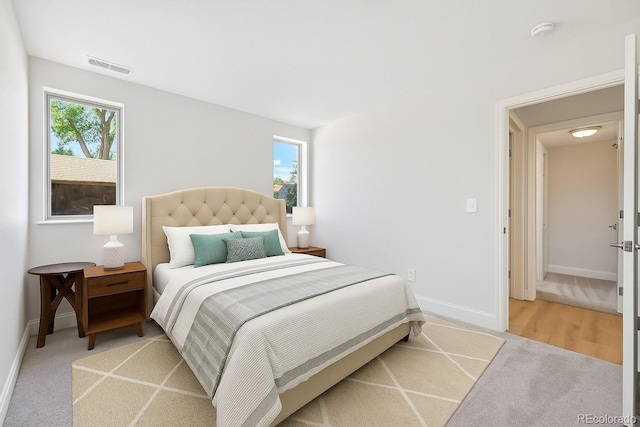 3365 Chisholm Trl Unit B102, Boulder, CO 80301 - bedroom with multiple windows, baseboards, and light carpet
