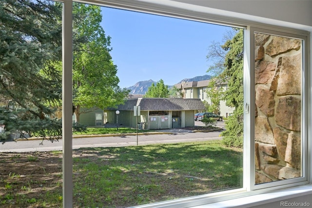 3365 Chisholm Trl Unit B102, Boulder, CO 80301 - view of front of property with a mountain view, a front yard, and a shingled roof