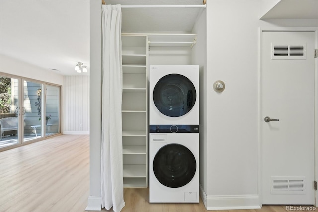 3365 Chisholm Trl Unit B102, Boulder, CO 80301 - laundry area with stacked washer and clothes dryer and wood finished floors