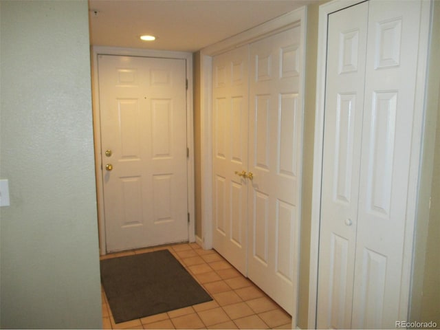 entryway with light tile patterned floors