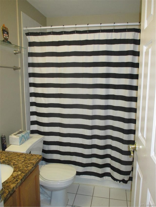 bathroom featuring tile patterned floors, curtained shower, vanity, and toilet