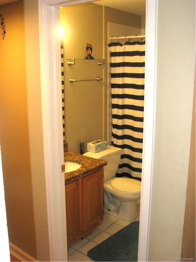 bathroom with tile patterned floors, vanity, toilet, and a shower with curtain