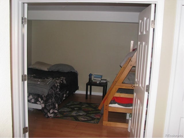 bedroom with hardwood / wood-style flooring