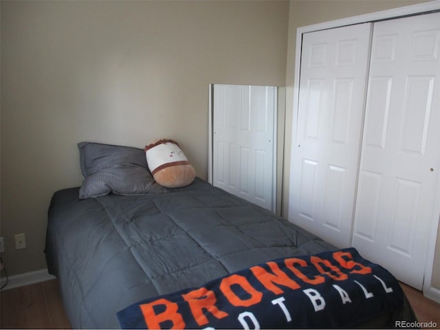 unfurnished bedroom with wood-type flooring and a closet