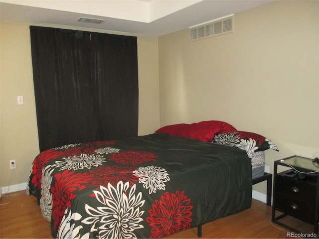 bedroom with hardwood / wood-style floors