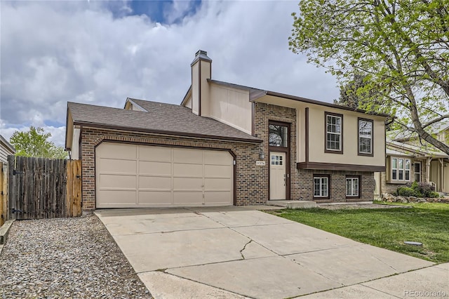 view of front of property with brick siding, an attached garage, driveway, and a chimney