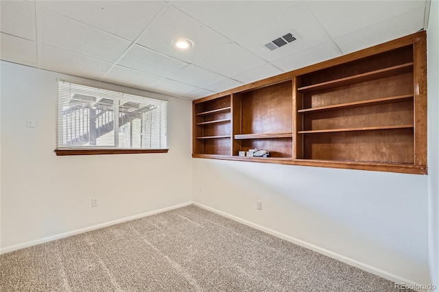 unfurnished room with baseboards and carpet flooring