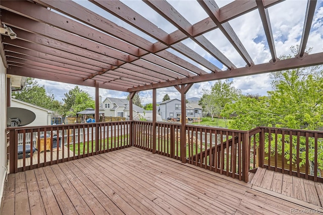 deck featuring a residential view, a pergola, and fence