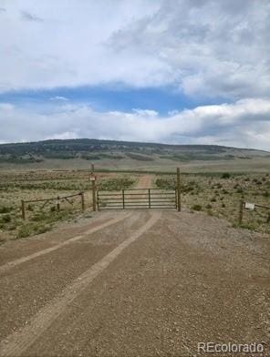 24870 US Highway 285, Fairplay, CO 80440 - view of street featuring a gate, a rural view, and a gated entry
