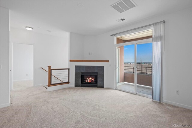 4100 Albion St Unit 320, Denver, CO 80216 - unfurnished living room with carpet floors and a lit fireplace
