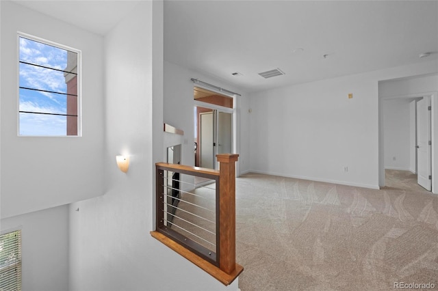 4100 Albion St Unit 320, Denver, CO 80216 - spare room with plenty of natural light, carpet floors, and a smoke detector