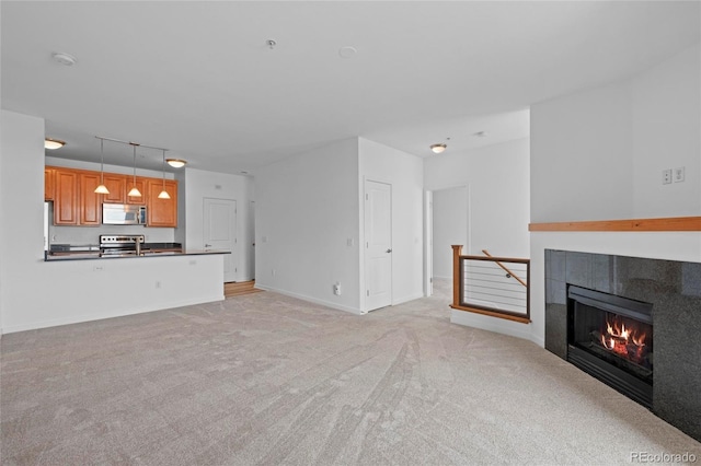 4100 Albion St Unit 320, Denver, CO 80216 - unfurnished living room featuring a tile fireplace and light carpet