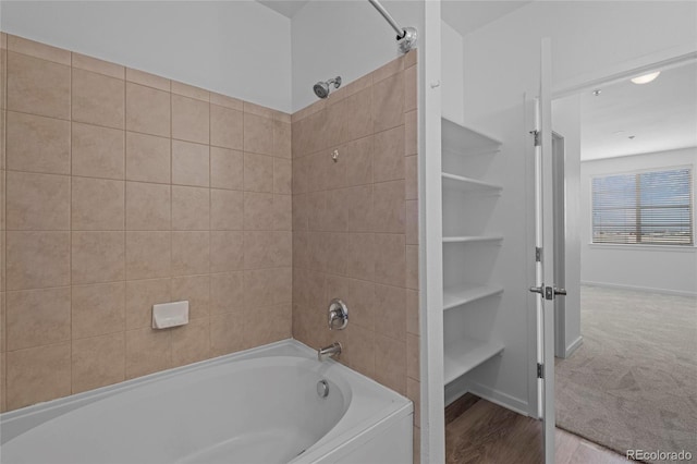 4100 Albion St Unit 320, Denver, CO 80216 - full bath featuring bathing tub / shower combination and wood finished floors