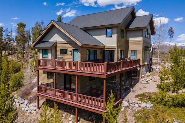 632 Gcr 662, Grand Lake, CO 80447 - back of property with a shingled roof, a deck, and stone siding