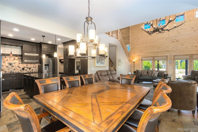 632 Gcr 662, Grand Lake, CO 80447 - dining area featuring recessed lighting, wood walls, a high ceiling, and a notable chandelier