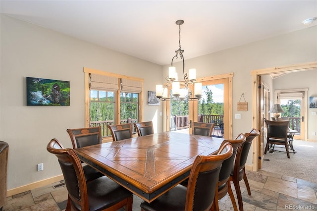 632 Gcr 662, Grand Lake, CO 80447 - dining space featuring stone tile flooring, baseboards, and a chandelier