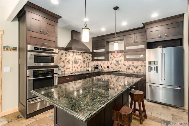 632 Gcr 662, Grand Lake, CO 80447 - kitchen with stone tile floors, a warming drawer, appliances with stainless steel finishes, and wall chimney exhaust hood