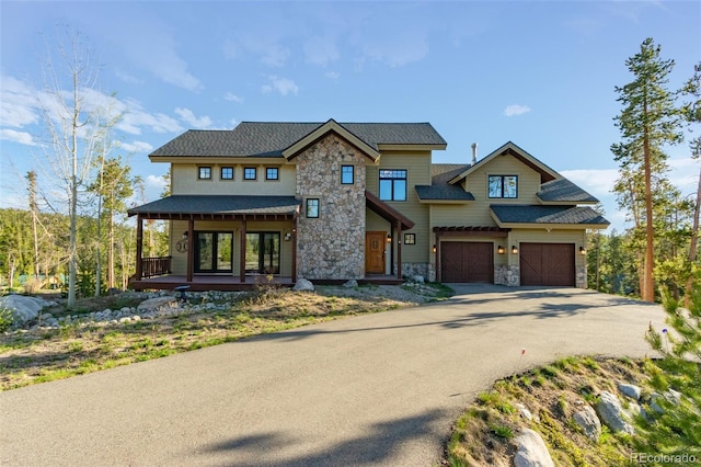 632 Gcr 662, Grand Lake, CO 80447 - view of front of home featuring a garage, a porch, driveway, and stone siding