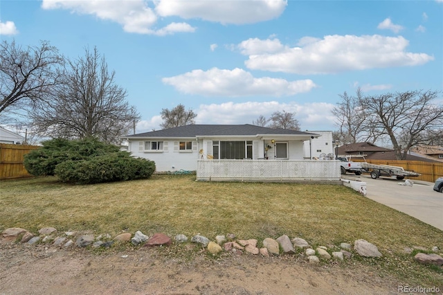 single story home with a front lawn and fence