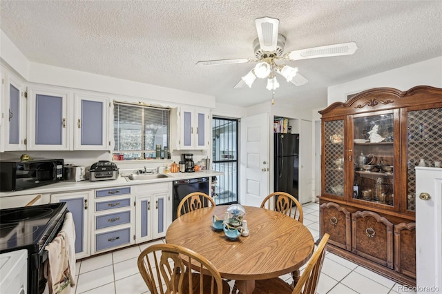 dining space featuring light tile patterned floors, a ceiling fan, and a textured ceiling