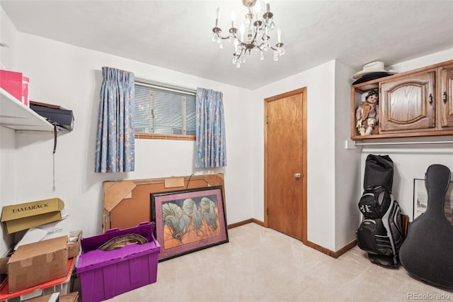 interior space with a chandelier, carpet flooring, and baseboards