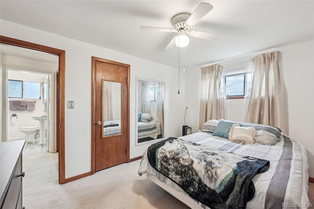 bedroom with light colored carpet, a ceiling fan, and baseboards