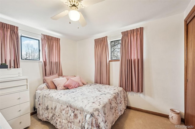 bedroom with baseboards, light colored carpet, and ceiling fan