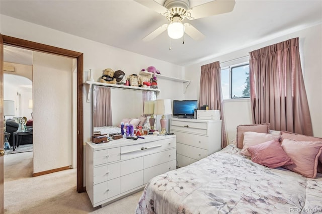 bedroom with light carpet and a ceiling fan