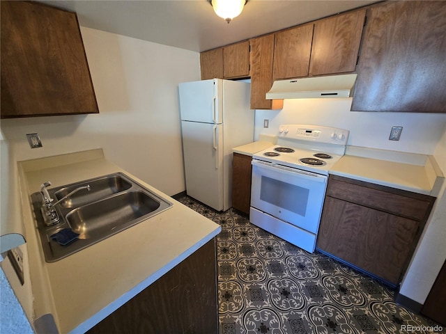 kitchen with light countertops, white appliances, a sink, and under cabinet range hood