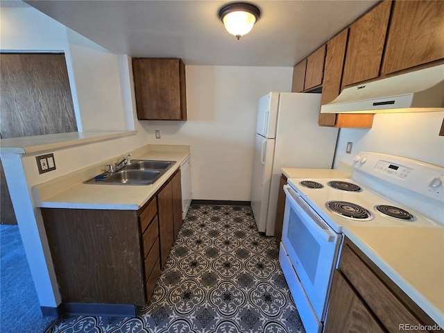 kitchen featuring white appliances, baseboards, light countertops, under cabinet range hood, and a sink