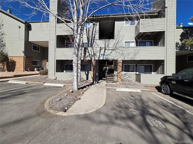 view of building exterior featuring uncovered parking