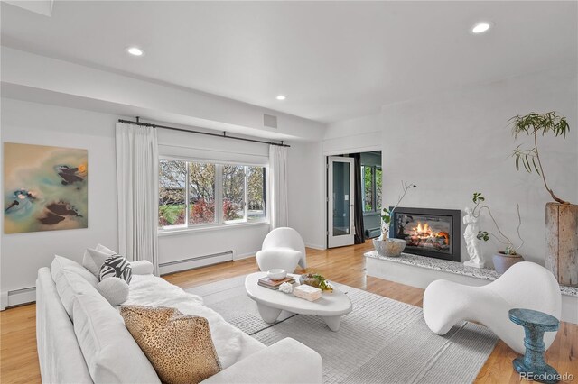 living room featuring recessed lighting and baseboard heating