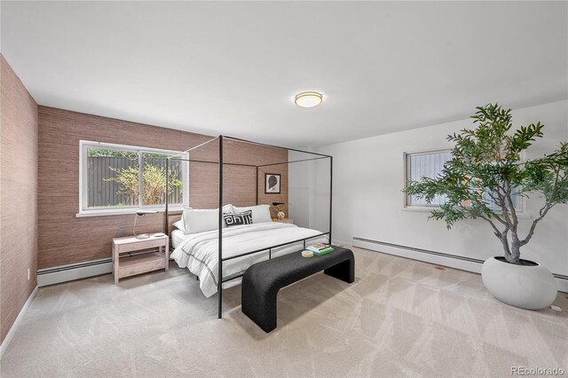 bedroom with baseboards, baseboard heating, and light carpet