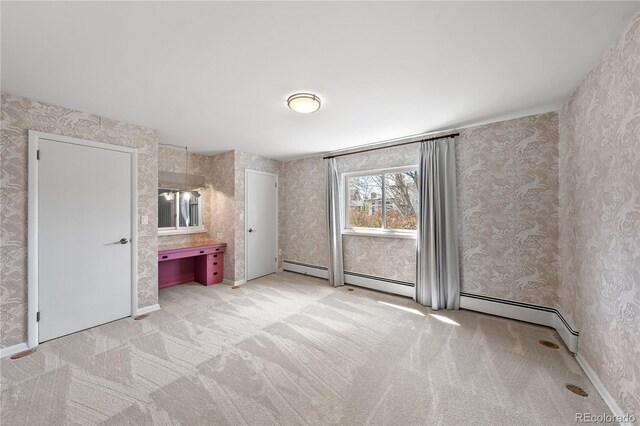 unfurnished bedroom with wallpapered walls and light colored carpet