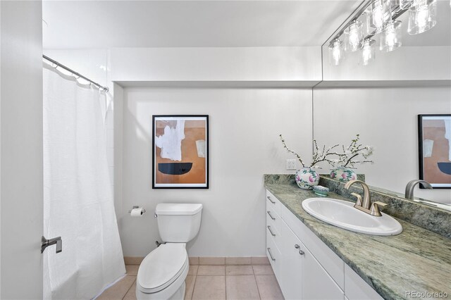 bathroom featuring curtained shower, vanity, tile patterned flooring, and toilet
