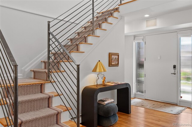 foyer featuring wood finished floors and stairs
