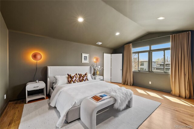 bedroom featuring recessed lighting, vaulted ceiling, light wood-style flooring, and visible vents