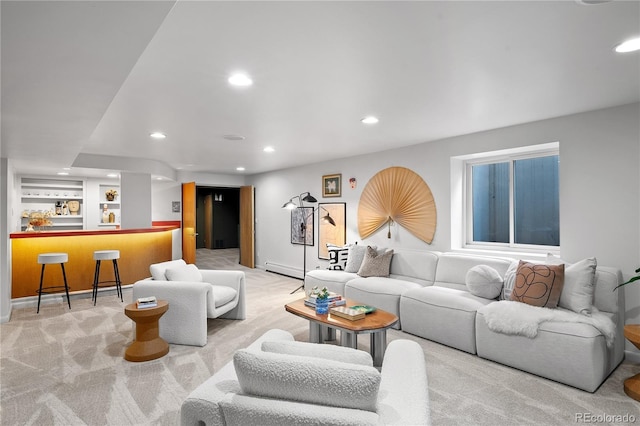 carpeted living room with bar, baseboards, and recessed lighting