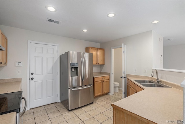 5531 S Quemoy Cir, Aurora, CO 80015 - kitchen with stainless steel fridge, range with electric cooktop, recessed lighting, light tile patterned floors, and light countertops
